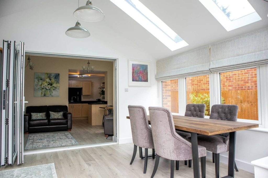 Internal view of a completed house extension, with velux rooflights and modern decor